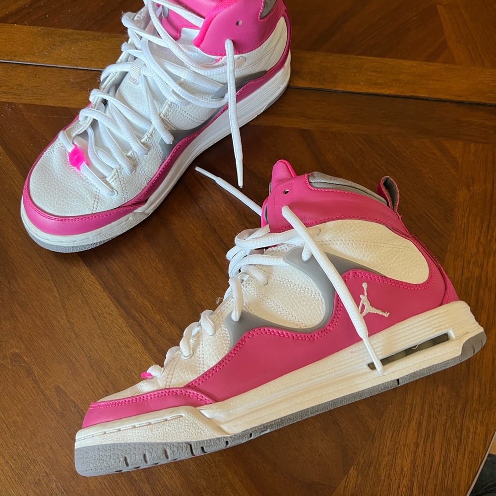 Pink and White Nike high top shoes